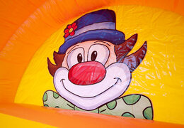 Spectacular inflatable slide in clown theme with cheerful colors for children. Buy inflatable slides now online at JB Inflatables UK