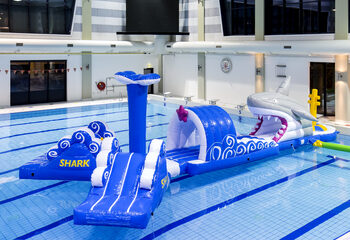 Inflatable 13 meter long shark run swimming pool obstacle course in a unique design with funny 3D objects and no less than 2 slides for both young and old. Order inflatable obstacle courses online now at JB Inflatables America